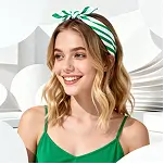 Smiling woman in green outfit posing in a modern white environment