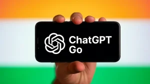 A person holding a smartphone with the text “ChatGPT Go” and the ChatGPT logo displayed on the screen, against the backdrop of the Indian flag with saffron, white, and green stripes.